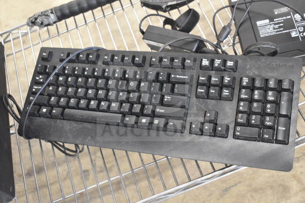 Computer keyboard on metal rack, part of auction lot with ProBreeze dehumidifier and Lenovo ThinkCentre. Used condition.