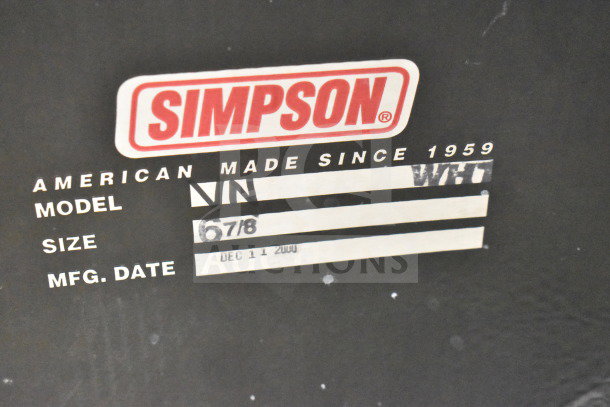 Simpson VN Helmet label with size 6-7/8, manufactured December 11, 2000. Black background, white label, red logo.