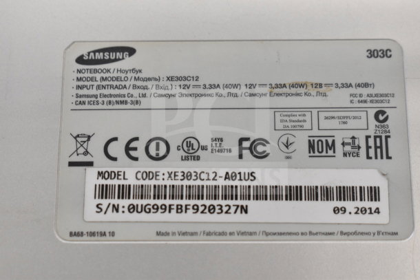 Samsung laptop model XE303C12 label, showing power details and serial number. Includes certifications and manufacturing info.