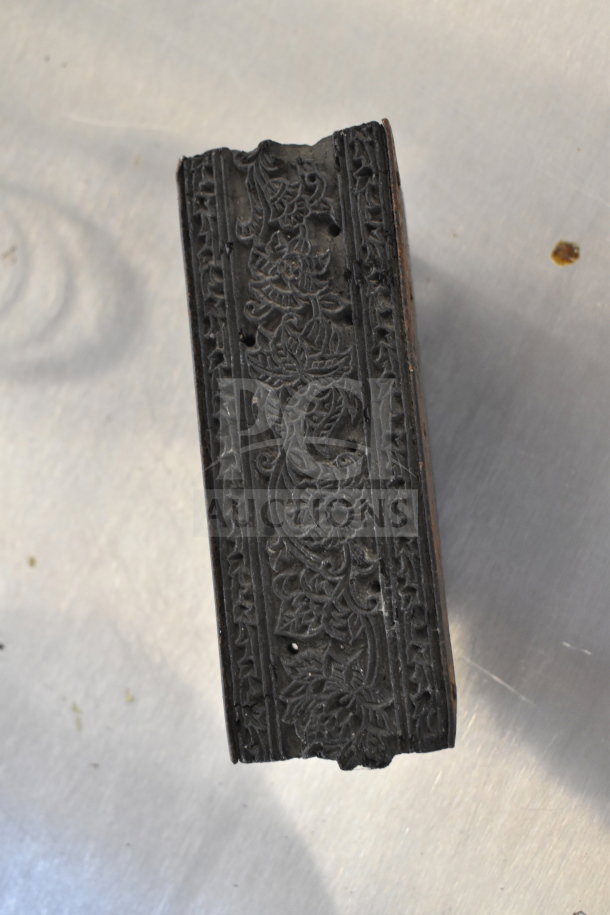 Antique wooden textile printing block with intricate floral carvings, slightly worn condition.