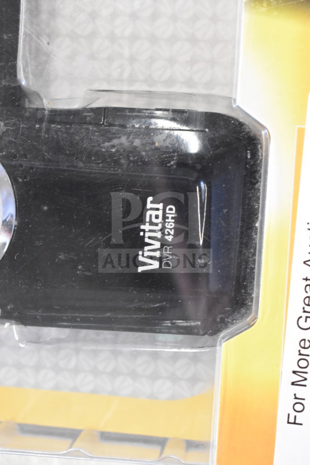 Vivitar DVR 426HD in packaging, visible branding. Part of an auction lot with iPods and smartphones.