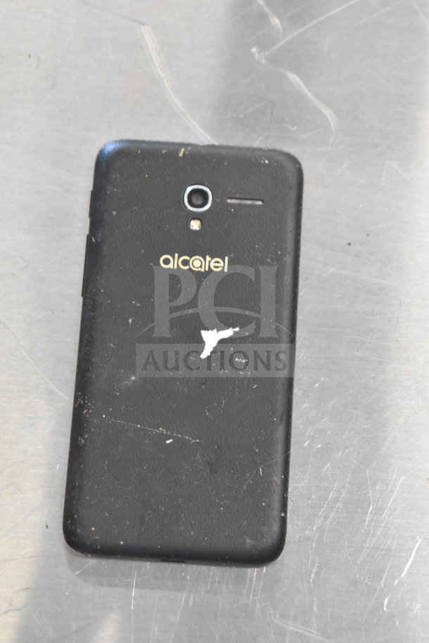 Alcatel smartphone with a black back, visible wear and minor scratches, "alcatel" logo on rear.