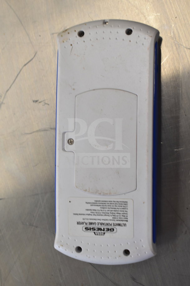 Genesis Ultimate Portable Game Player, white and blue, back view, worn condition with visible markings and label.