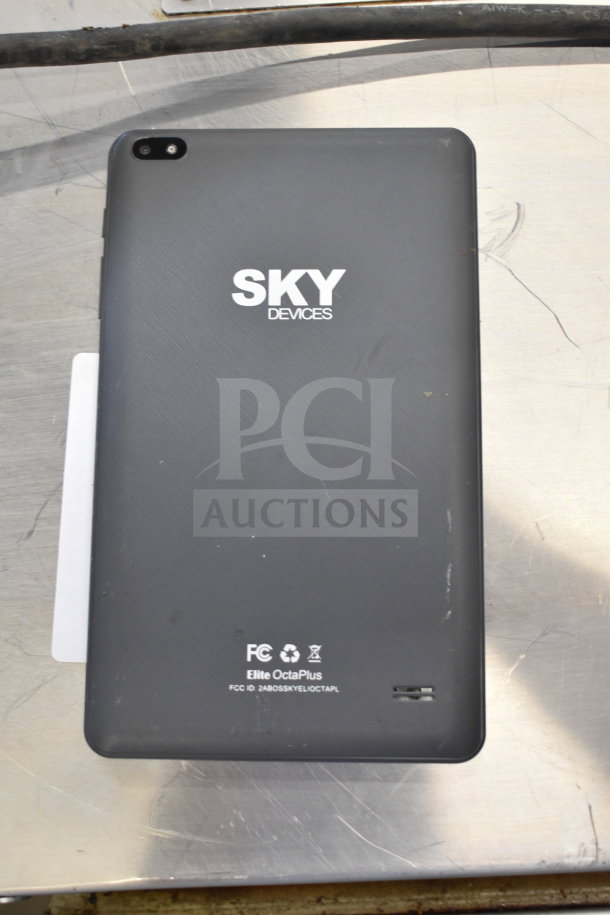 "Sky Devices Elite OctaPlus tablet back, gray color, visible logos and FCC ID. Part of 7-item auction lot."