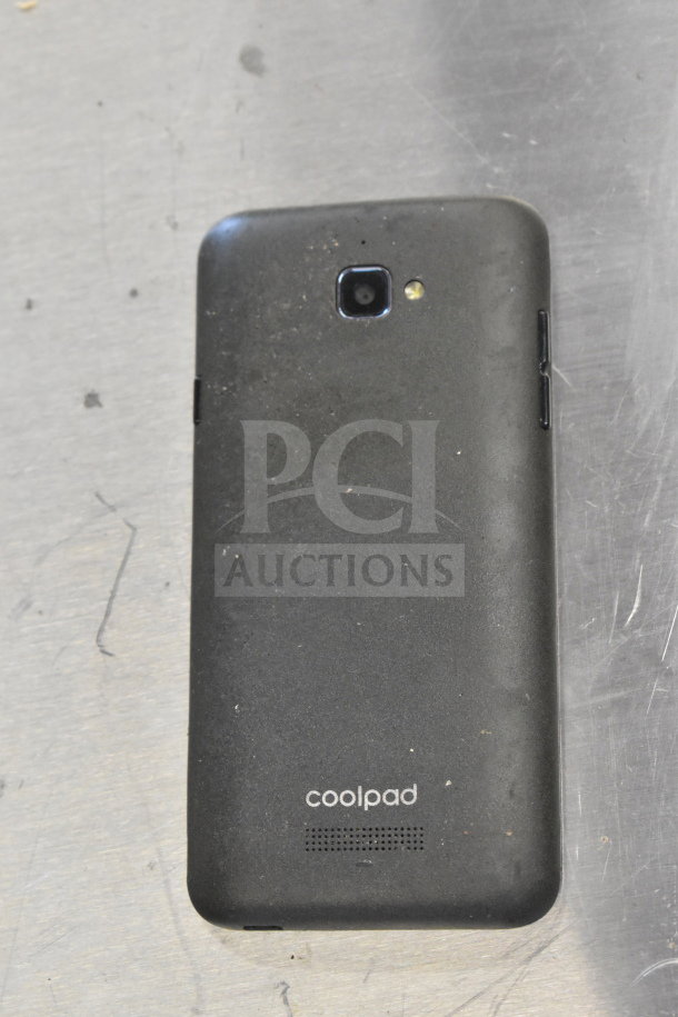 Back of a Coolpad smartphone, used, showing back camera and flash. Part of a lot including Genesis Ultimate Portable Game Player.
