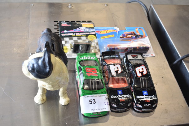 6 items including a vintage dog piggy bank, Hot Wheels car, and die-cast race cars. Tags show auction lot number 53.
