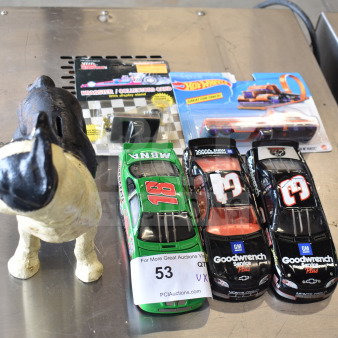 6 items including a vintage dog piggy bank, Hot Wheels car, and die-cast race cars. Tags show auction lot number 53.