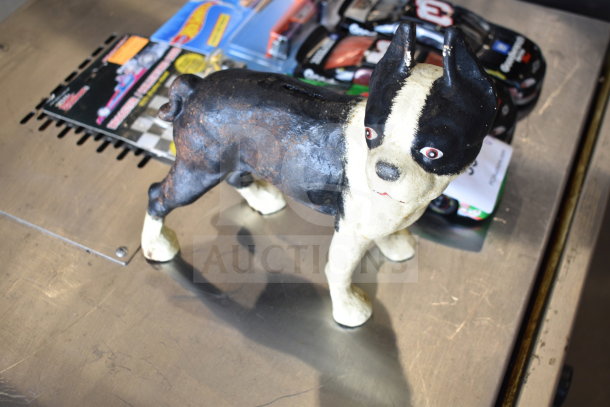 Vintage dog piggy bank, two Hot Wheels packages, and die-cast cars. Items are in good condition.