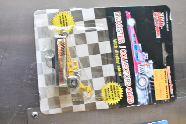 "Dragster II Collectors Card in original packaging, featuring a yellow die-cast car with display stand, Racing Champions brand."