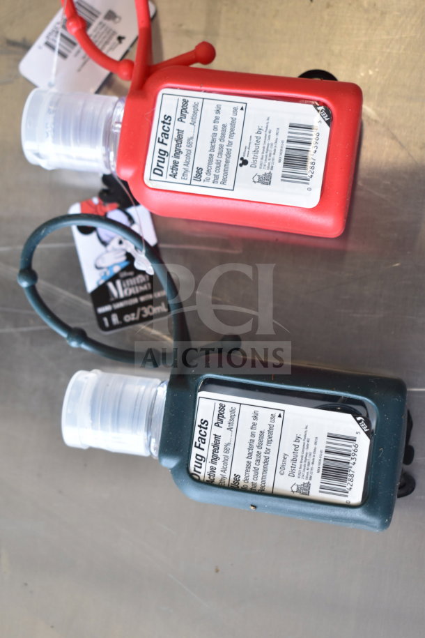 Two hand sanitizer bottles with cozies, red and green, each labeled with drug facts and attached via loop handles.