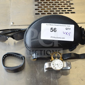 5 assorted items: sunglasses, black case, fitness watch, two analog watches. Auction label "56 QTY VXS" visible.