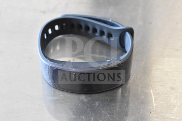 Black fitness watch with perforated strap, used condition, part of a lot with sunglasses and watches.