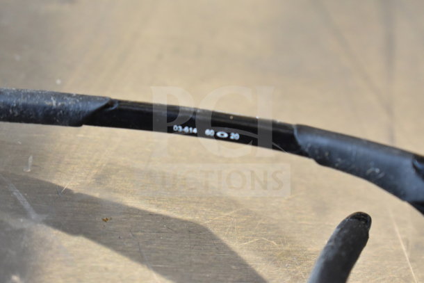 Close-up of black sunglass arm showing model number 03-614 and size 60-20, suggesting style and fit details.