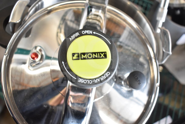Brand new Monix pressure pot, minor scratches and dents. Features stainless steel lid with Monix logo on yellow knob.