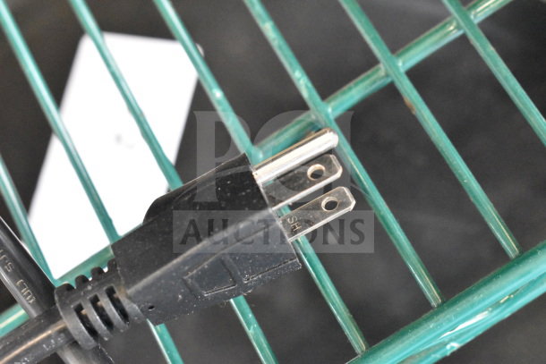 Plug of a Sephra SEHTDPMO110-01 Heated Pump on a green wire rack; power cord visible. Item is brand new, with minor scratches.