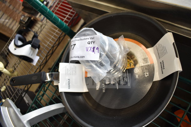 9 brand new scratch and dent items including a stainless steel malt cup collar and Vollrath fry pan, labeled and packaged.