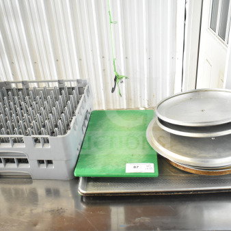 11 kitchen items including a green cutting board, metal baking pans, and a grey dish caddy. Quantity label: 11.