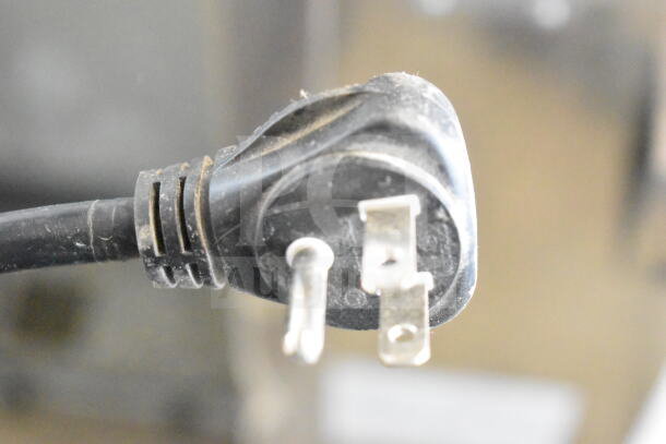 Close-up of a power plug for Turbo Air PST-28-12-D2-N commercial prep table, 115 Volts, 1 Phase, showing wear.