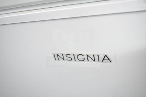 Insignia NS-CZ70WH0 chest freezer, visible brand label, 115 volts, 1 phase, white finish.