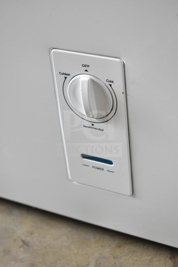 Insignia NS-CZ70WH0 chest freezer control panel showing temperature dial and power indicator.