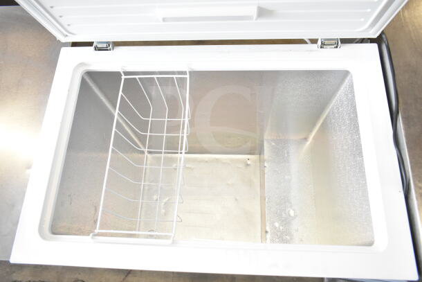 Insignia NS-CZ70WH0 chest freezer, open lid, white interior, wire basket, 115 volts, 1 phase, excellent condition.