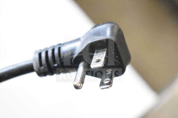 Power plug of Insignia NS-CZ70WH0 chest freezer, 115 volts, 1 phase. Close-up shows standard three-prong configuration.