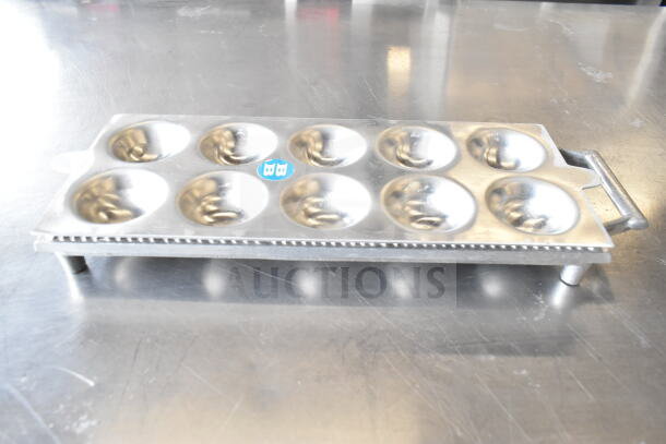 Metal ravioli form with twelve round molds and dual handles, in good condition. Blue "BB" label on top.