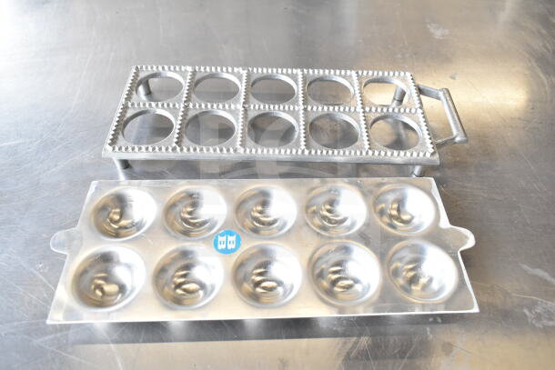 Metal ravioli form with grid and scalloped edges, includes base with rounded cavities. Good condition, minor surface marks.