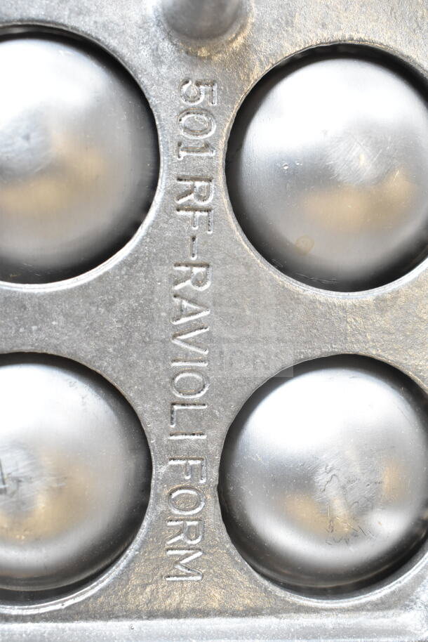 Metal ravioli form with "501 RF-RAVIOLI FORM" marking, featuring multiple rounded molds, in good used condition.