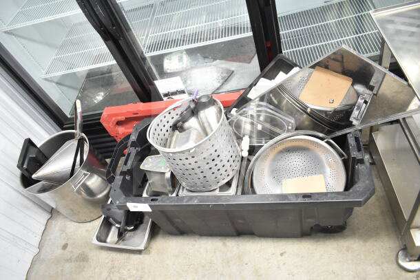 Lot of kitchen items including colander, stock pot, China cap strainer, and air pot in a plastic bin. Mixed condition.