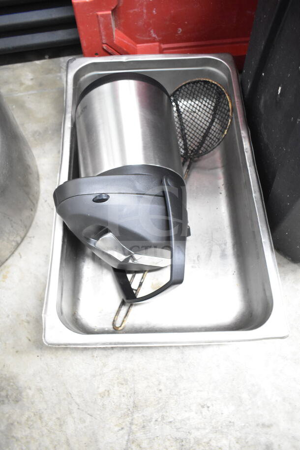 Lot of various kitchen items including a metal air pot and mesh strainer. Items are placed in a metal tray.