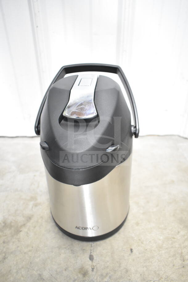 Stainless steel Acopa air pot with black top and handle, showing its sturdy design and good condition.