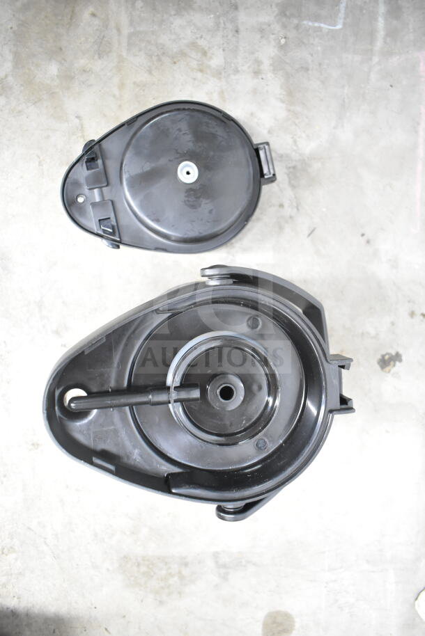 Lot of kitchen items including black colander and lids, featuring durable plastic construction and easy-clean surfaces.