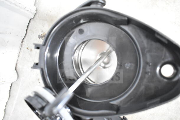 Alt text: Interior view of a black and stainless steel air pot, part of a lot including a colander, stock pot, and China cap strainer.