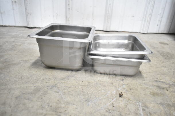Stainless steel food pans, various sizes, used condition, part of a mixed lot including colander, stock pot, and more.