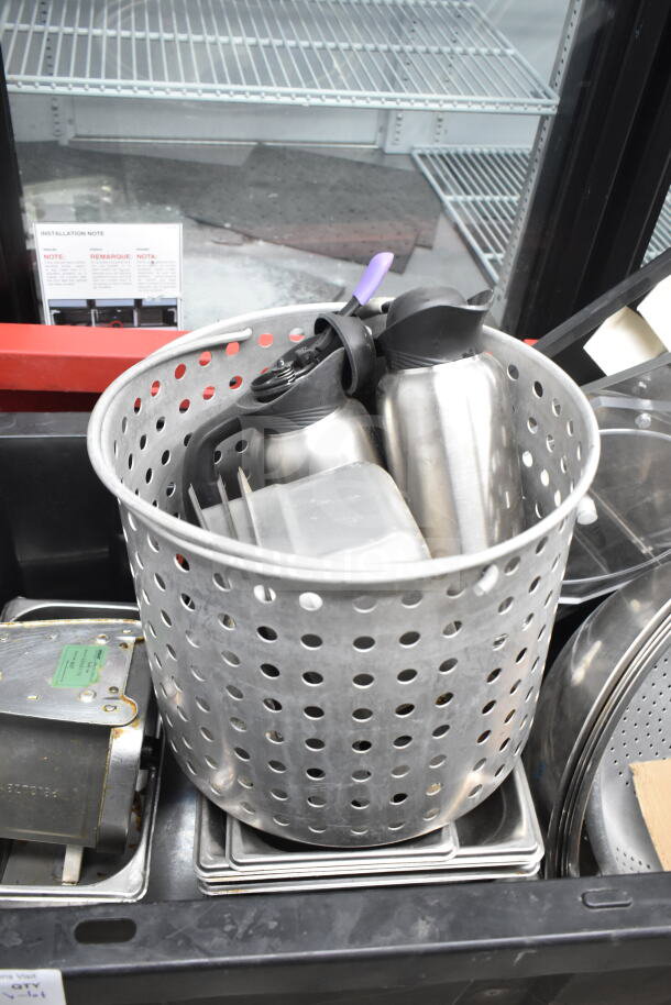 Lot of various kitchen items including a perforated colander, stock pot, and air pot. Some items stacked; condition varies.