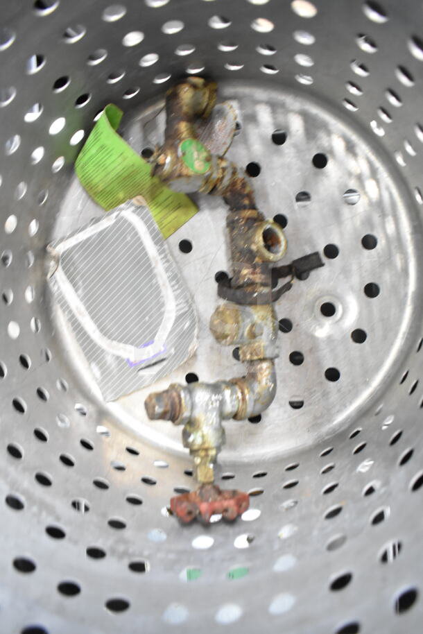 "Lot of items: perforated metal colander, rusted valve, green tag, and more. Mixed condition."