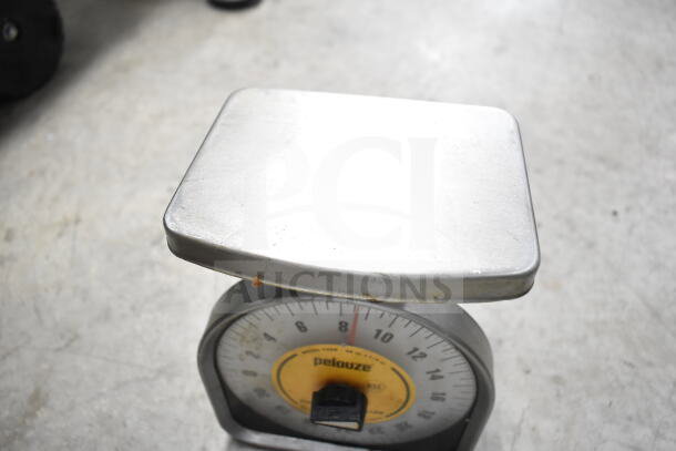 Pelouze mechanical scale, silver with yellow dial, visible marks and wear, includes various items like colander and stock pot.