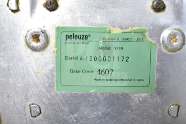 Pelouze model Y32R scale label, serial 1200001172, date code 4607, manufactured in China, attached to metal surface.