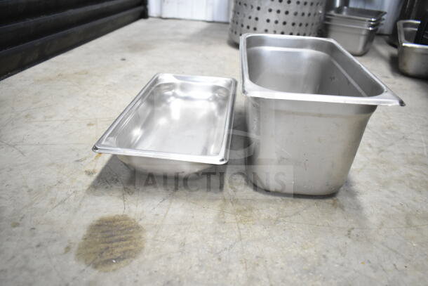 Lot of stainless steel kitchen items including rectangular pans; shows moderate wear, ideal for commercial use.