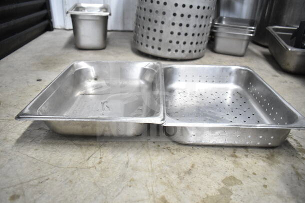 Lot of industrial kitchen items including colander, perforated pan, and stock pot, showing signs of wear.