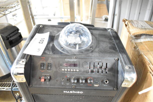 Masingo Soprano X1 karaoke machine with control panel, microphone inputs, and LED dome light. Slightly dusty condition.