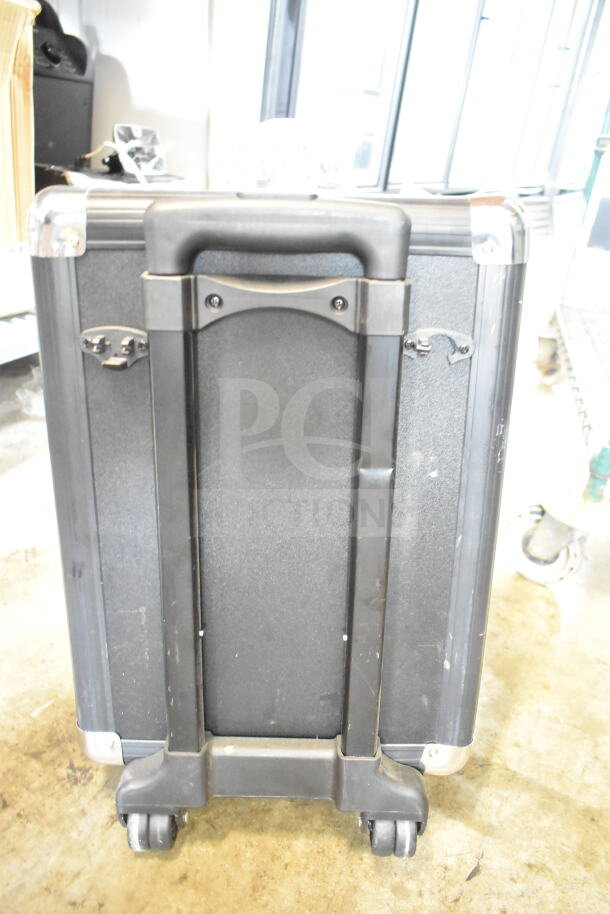 Masingo Soprano X1 Karaoke Machine in black casing with wheels. Features include a telescoping handle and metal corner protectors.