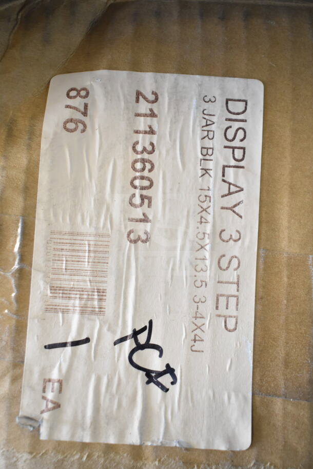 Cardboard box labeled "DISPLAY 3 STEP, 211360513, 3 JAR BLK 15x4.5x13.5" with black marker notation "PC".