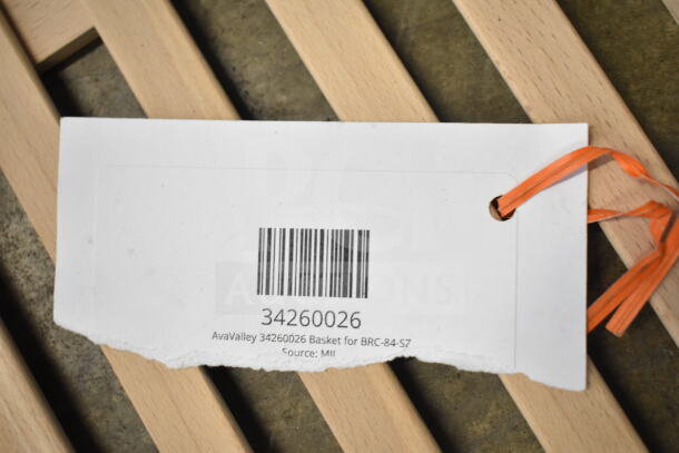 Auction lot image showing a tag with barcode and text "AvaValley 34260026 Basket for BRC-84-SZ, Source: MII" attached to a wooden item.