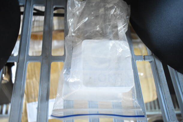 Brand new deli tag blanks and write-on tags in packaging on metal shelf, including 512XKD105 and 512XKD710BK models.