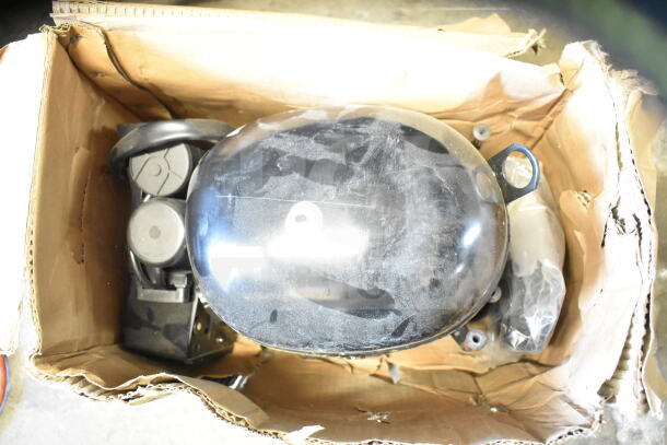 Embraco NT6222UV compressor in a box, 115 volts, 1 phase, visible wear, parts included.