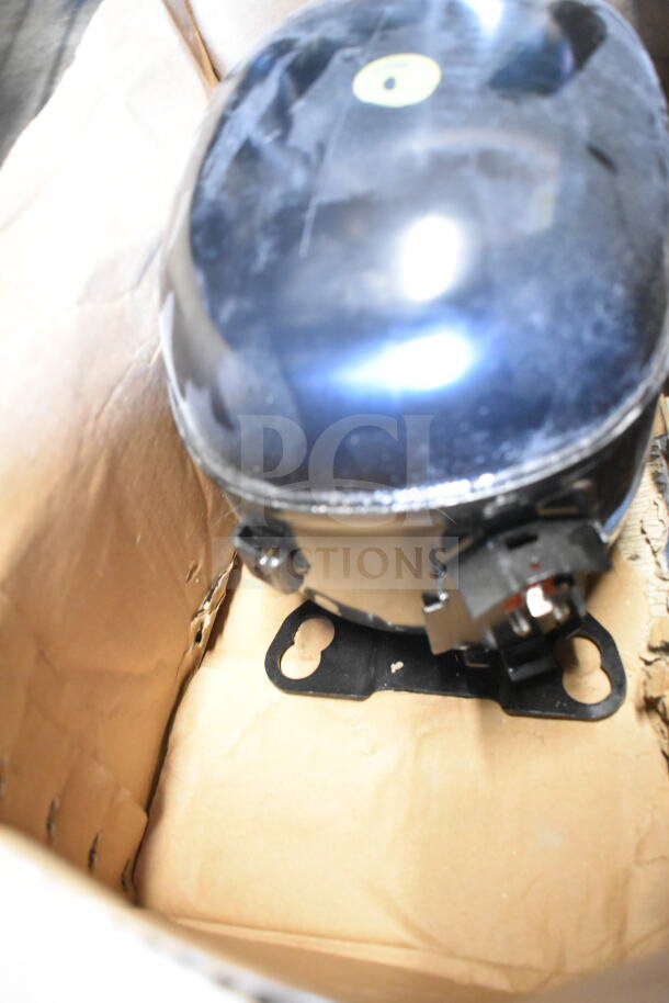 Embraco NT6222UV Compressor, 115 Volts, 1 Phase, in new condition, shown in a cardboard box.