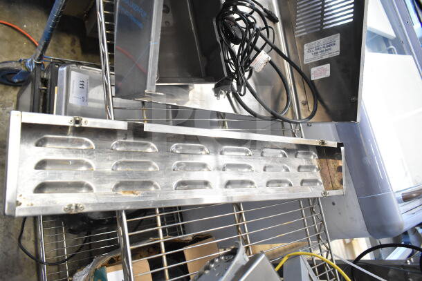 Various metal components including vented metal panels and legs. Additional cables visible. Auction lot of 9 items.