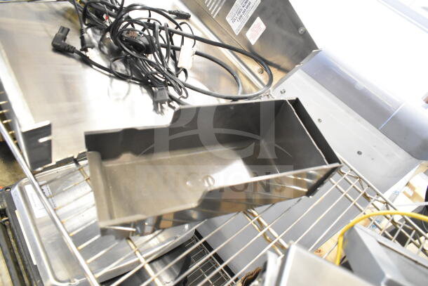 Nine assorted industrial items including stainless steel trays, metal panels, and electrical cords in used condition.